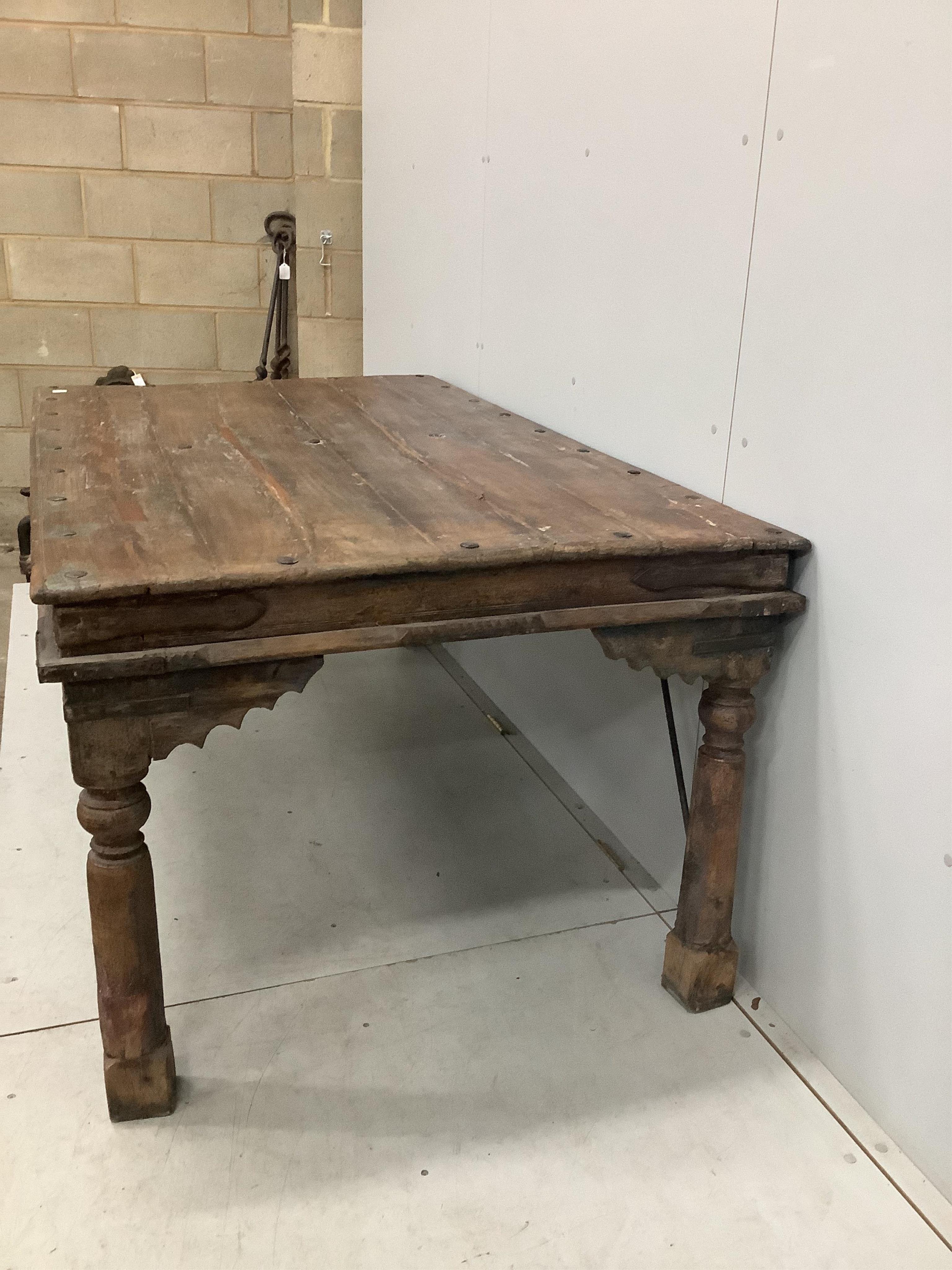 An Indian iron mounted rectangular hardwood table, width 182cm, depth 106cm, height 79cm. Condition - fair